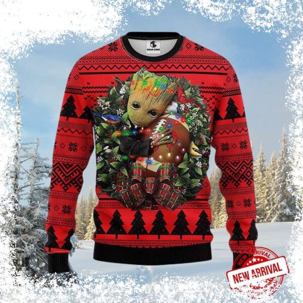 Show your Tampa Bay Buccaneers pride this holiday season with this hilarious Groot Holding Football In Wreath Ugly Xmas Sweater! Perfect for game day or holiday gatherings. Shop now and spread some fe - Image 1 - rugbyfanstore.com