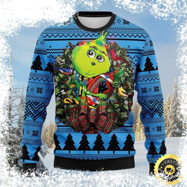 Show your Carolina Panthers pride this Christmas with this unique sweater featuring a Grinch football wreath design. Shop now and get ready to cheer on your team in style! - Image 1 - rugbyfanstore.com